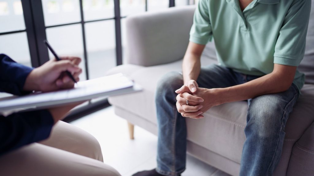 Person meeting with a therapist to discuss alcohol rehab treatment options