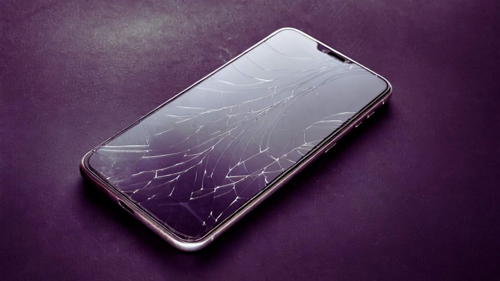 Cracked smartphone symbolizing disruption and consequences of alcohol misuse
